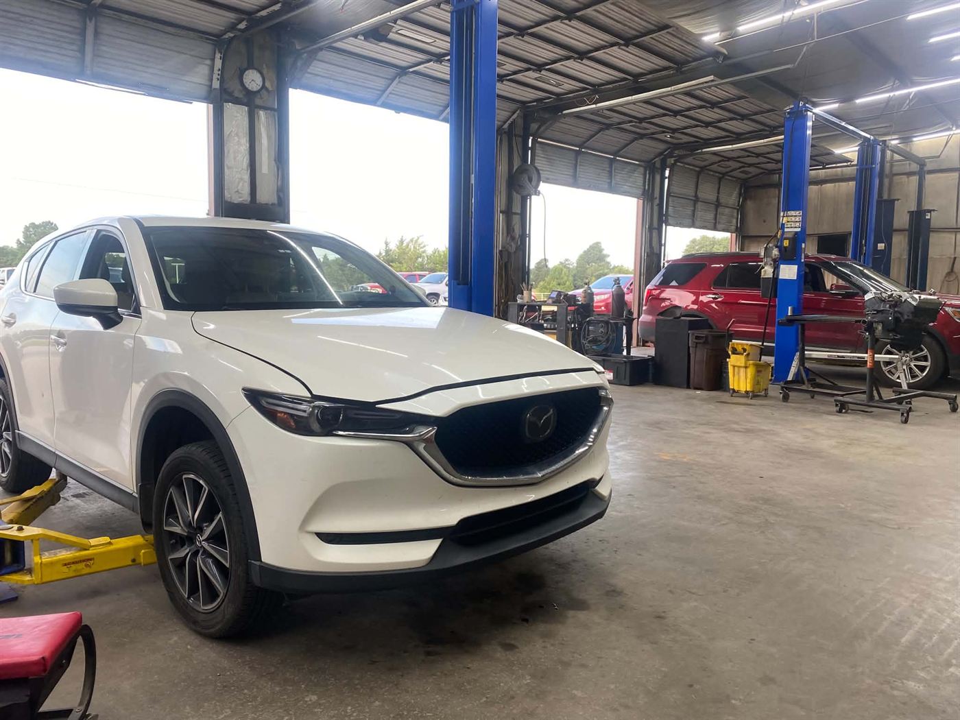 SUV in for service inside the shop at Country Auto Service in McLoud, OK